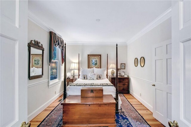 bedroom with light wood-type flooring and crown molding