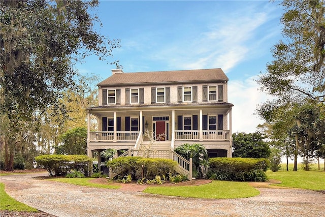 colonial house with a porch and a front yard