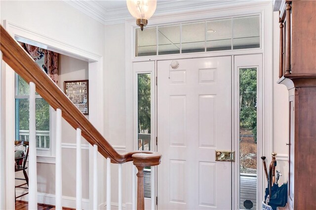 foyer featuring hardwood / wood-style flooring and ornamental molding