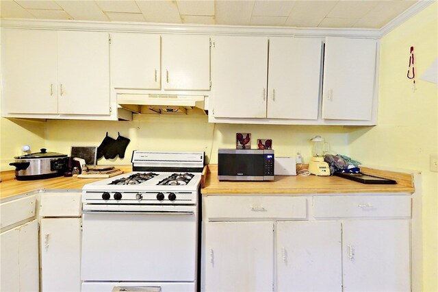 1013 E Waring St, Waycross, GA 31501 - kitchen with white cabinets, ornamental molding, and gas range gas stove