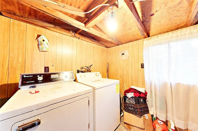 washroom with wood walls, washing machine and dryer, and wooden ceiling