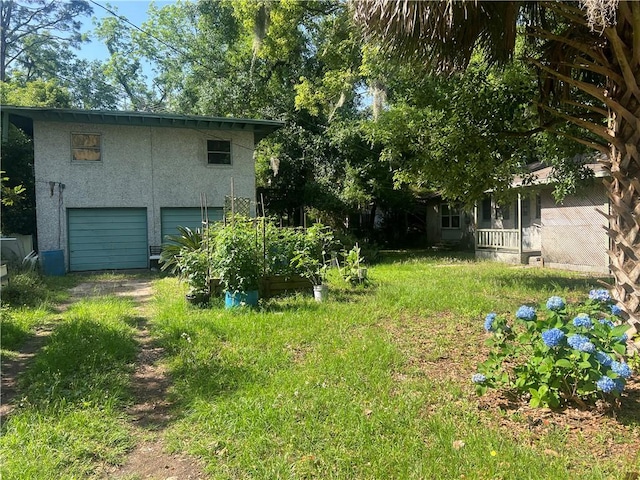 3228 Reynolds St, Brunswick, GA 31520 - view of yard with a garage and driveway