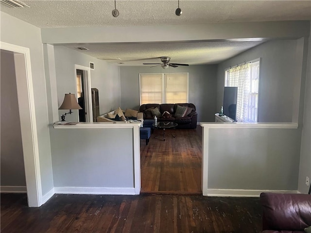 3228 Reynolds St, Brunswick, GA 31520 - living area featuring hardwood / wood-style flooring, a ceiling fan, a textured ceiling, and baseboards