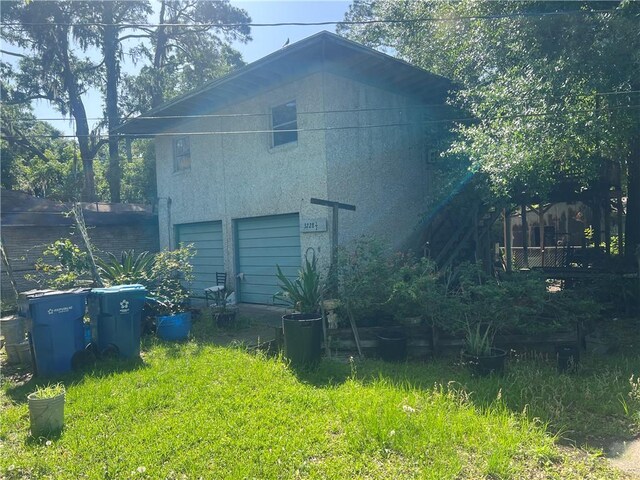 3228 Reynolds St, Brunswick, GA 31520 - view of side of home with an attached garage and stucco siding