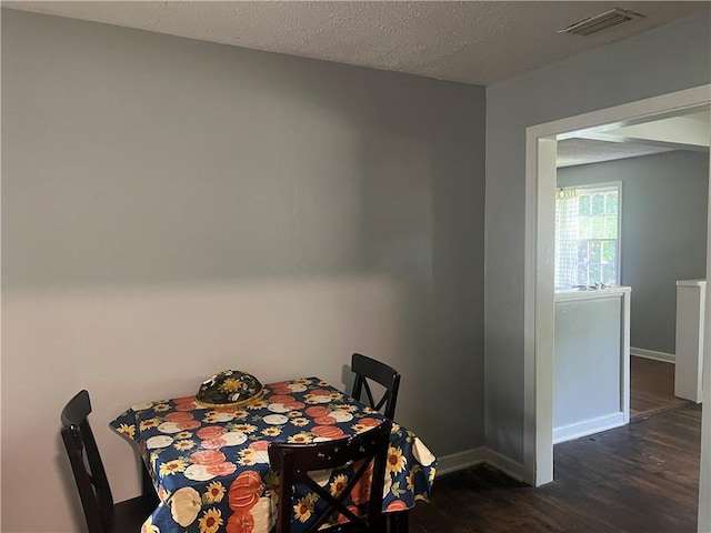 3228 Reynolds St, Brunswick, GA 31520 - dining room featuring dark wood-style flooring, baseboards, and a textured ceiling