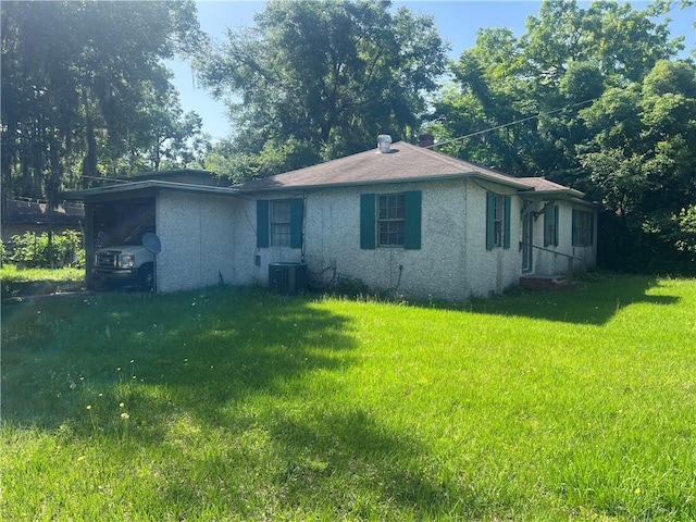 3228 Reynolds St, Brunswick, GA 31520 - view of front of house featuring a front yard, stucco siding, and central AC