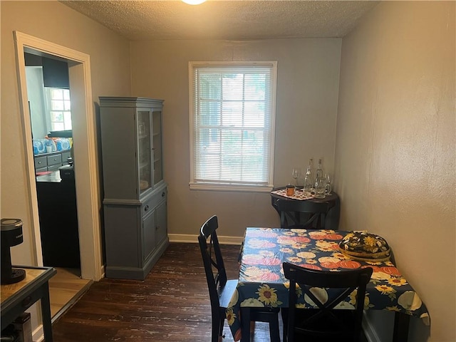3228 Reynolds St, Brunswick, GA 31520 - dining room with wood-type flooring, a textured ceiling, and baseboards