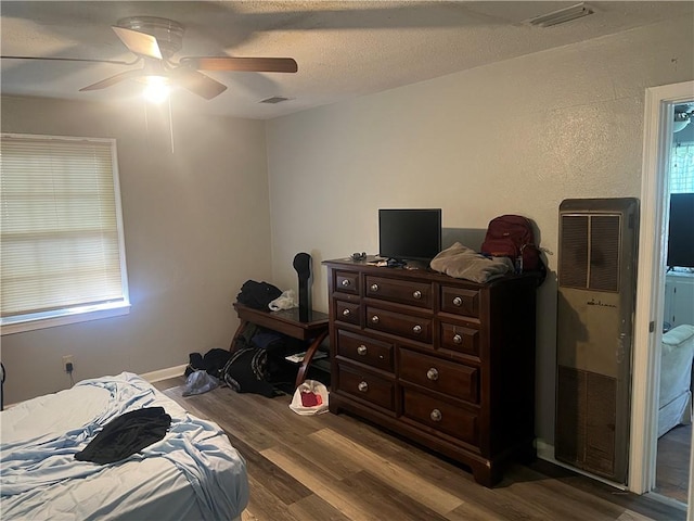3228 Reynolds St, Brunswick, GA 31520 - bedroom with wood finished floors, a heating unit, and a ceiling fan