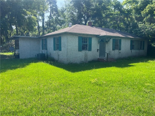 3228 Reynolds St, Brunswick, GA 31520 - single story home with a front yard, stucco siding, central AC, and a chimney