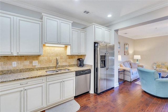 kitchen with white cabinets, sink, stainless steel appliances, and dark wood-type flooring