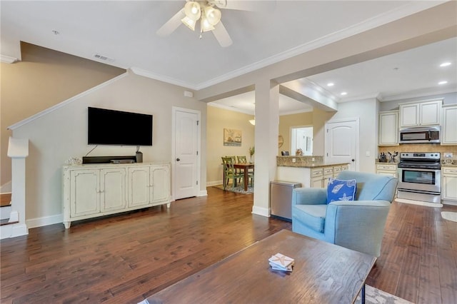 living room featuring dark hardwood / wood-style floors, ceiling fan, and ornamental molding