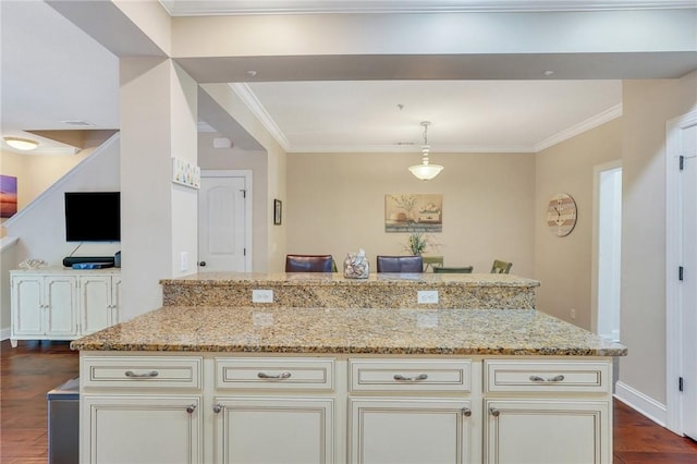 kitchen featuring pendant lighting, dark hardwood / wood-style floors, light stone counters, and crown molding