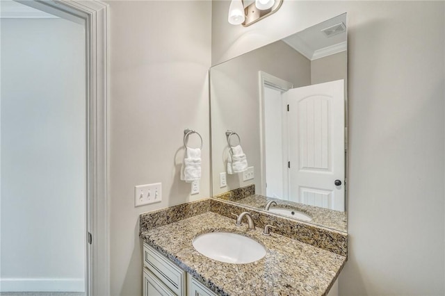 bathroom with vanity and ornamental molding