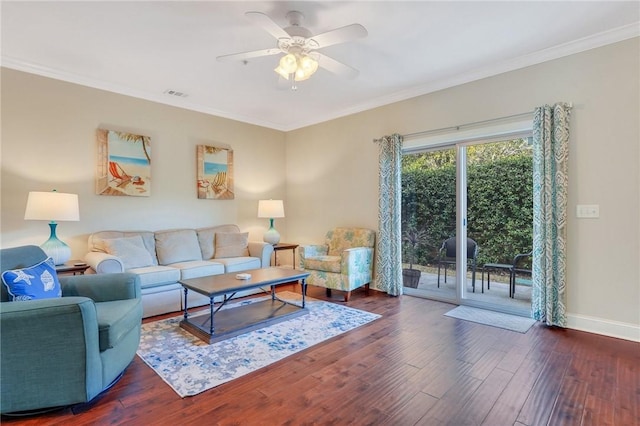 living room featuring dark hardwood / wood-style flooring, ceiling fan, and ornamental molding