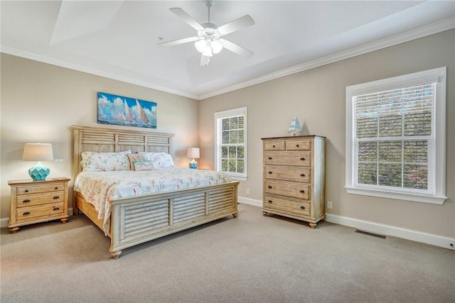 carpeted bedroom featuring multiple windows, ceiling fan, and crown molding