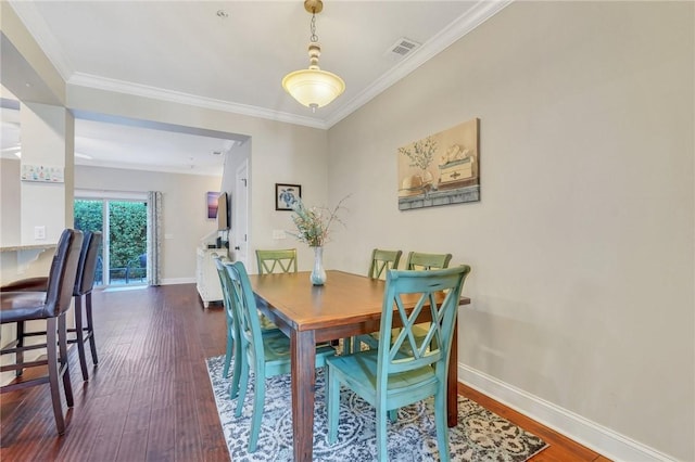 dining room featuring dark hardwood / wood-style flooring and ornamental molding