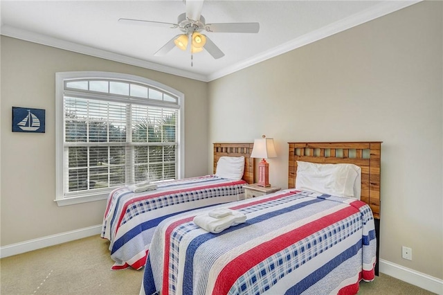 carpeted bedroom with ceiling fan and ornamental molding