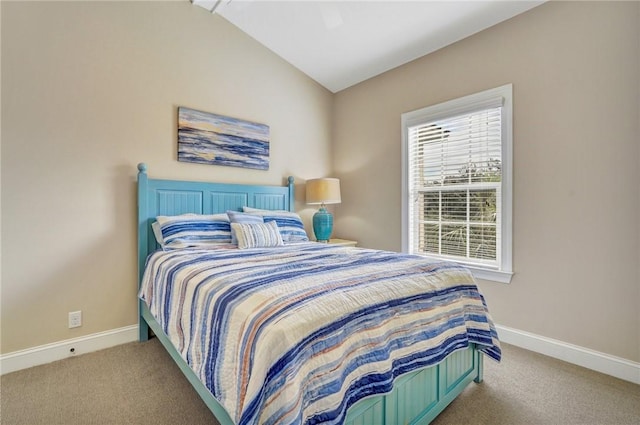 carpeted bedroom with ceiling fan and vaulted ceiling