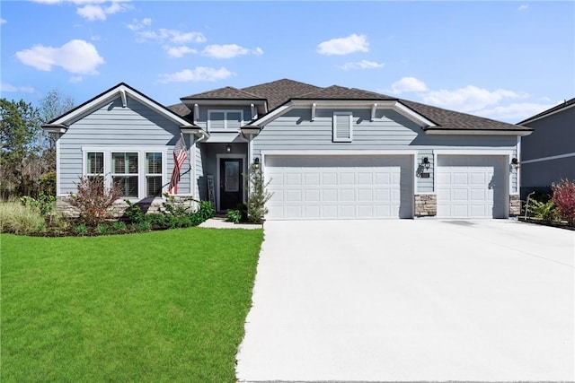 view of front of property featuring a shingled roof, an attached garage, stone siding, driveway, and a front lawn