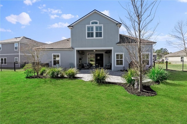 back of house with a patio area, a fenced backyard, a lawn, and stucco siding