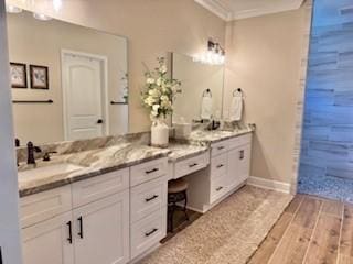 bathroom with vanity, wood-type flooring, and ornamental molding