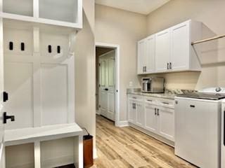 mudroom with washer / dryer and light hardwood / wood-style flooring