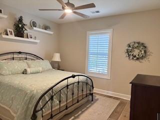 bedroom with ceiling fan and hardwood / wood-style floors