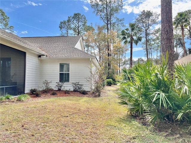 view of side of property with a yard