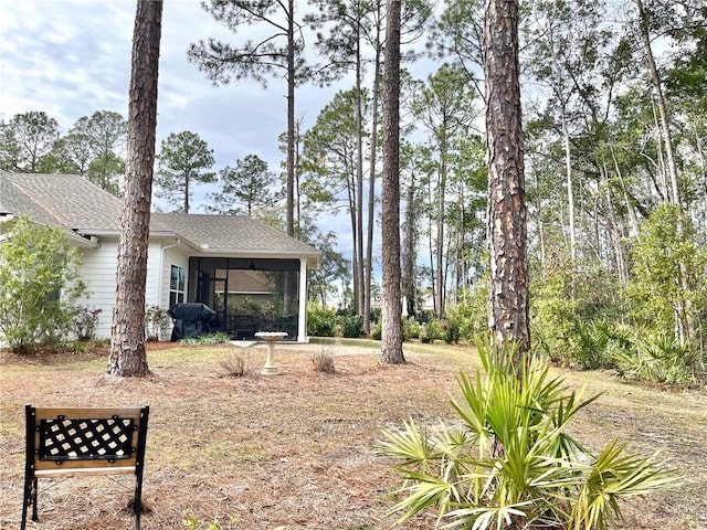 view of yard with a sunroom