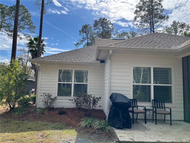 view of side of home with a patio