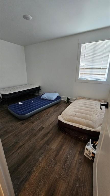 bedroom featuring wood finished floors and baseboards