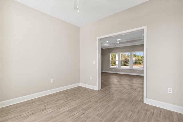 spare room featuring light hardwood / wood-style floors and ceiling fan