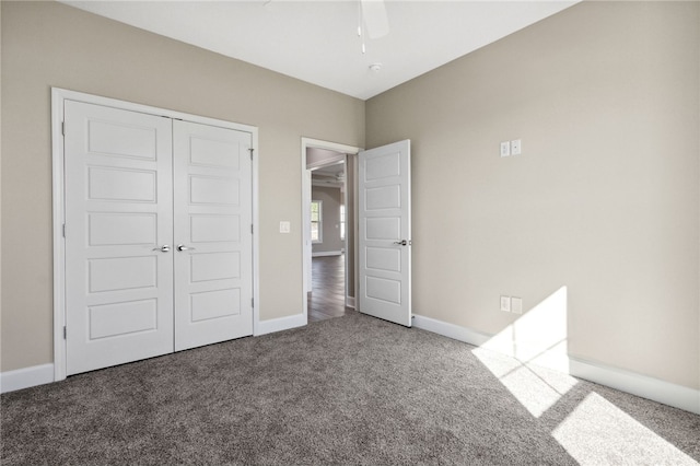 unfurnished bedroom featuring ceiling fan, carpet floors, and a closet