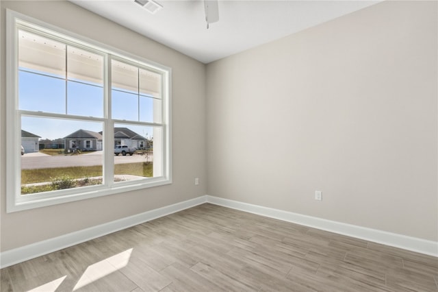 unfurnished room featuring ceiling fan and light hardwood / wood-style flooring