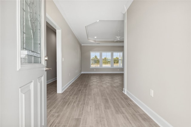 interior space featuring a tray ceiling, ceiling fan, light hardwood / wood-style floors, and crown molding