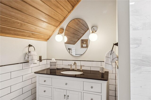 1232 Riverpoint Ln NE, Townsend, GA 31331 - bathroom with wood ceiling, lofted ceiling, vanity, and tile walls