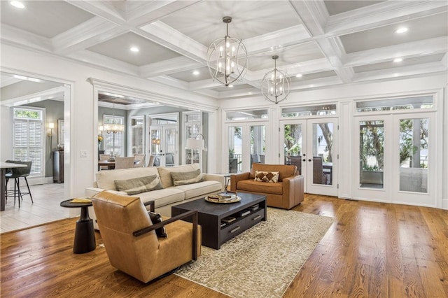 1232 Riverpoint Ln NE, Townsend, GA 31331 - living area with french doors, a chandelier, coffered ceiling, recessed lighting, and wood finished floors