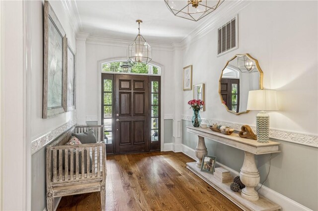 1232 Riverpoint Ln NE, Townsend, GA 31331 - entryway featuring ornamental molding, a chandelier, and wood finished floors