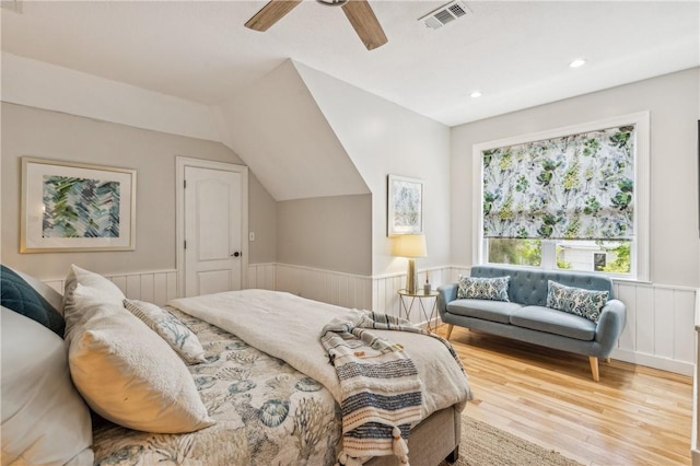 1232 Riverpoint Ln NE, Townsend, GA 31331 - bedroom with a wainscoted wall, wood finished floors, vaulted ceiling, ceiling fan, and recessed lighting