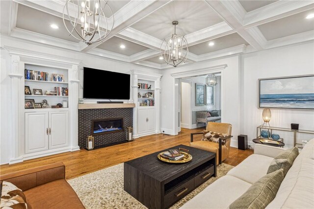 1232 Riverpoint Ln NE, Townsend, GA 31331 - living area with a chandelier, wood finished floors, coffered ceiling, beamed ceiling, and a tile fireplace