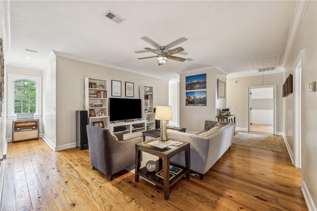 1232 Riverpoint Ln NE, Townsend, GA 31331 - living area featuring attic access, light wood finished floors, crown molding, ceiling fan, and baseboards