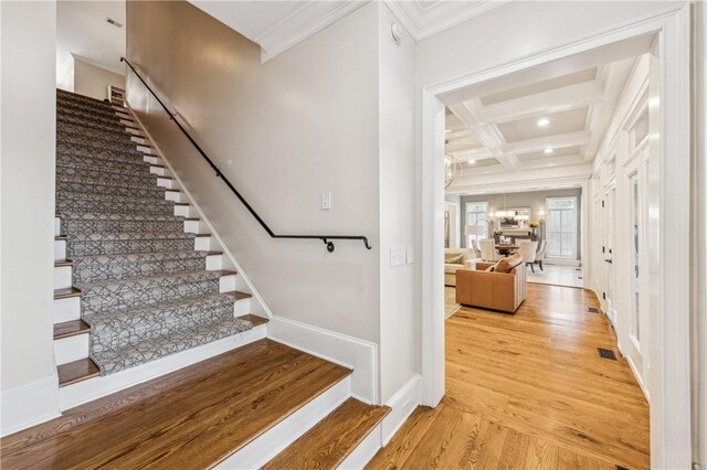 1232 Riverpoint Ln NE, Townsend, GA 31331 - stairs featuring ornamental molding, coffered ceiling, wood finished floors, baseboards, and beam ceiling