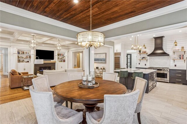 1232 Riverpoint Ln NE, Townsend, GA 31331 - dining area with crown molding, a chandelier, light wood-style flooring, a tiled fireplace, and recessed lighting