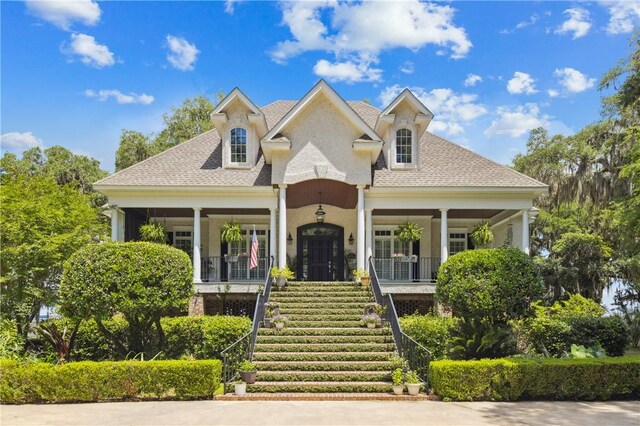 1232 Riverpoint Ln NE, Townsend, GA 31331 - view of front of house featuring stairs, a porch, and a shingled roof