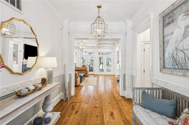 1232 Riverpoint Ln NE, Townsend, GA 31331 - corridor with a chandelier, ornamental molding, wood finished floors, and french doors