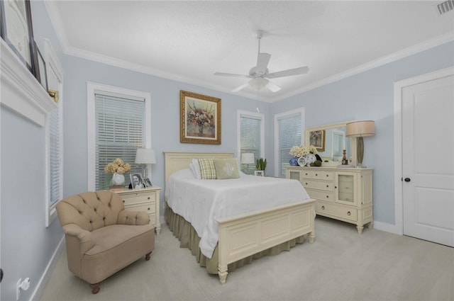bedroom featuring crown molding, baseboards, light colored carpet, and a ceiling fan