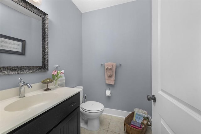 bathroom featuring toilet, vanity, tile patterned flooring, and baseboards