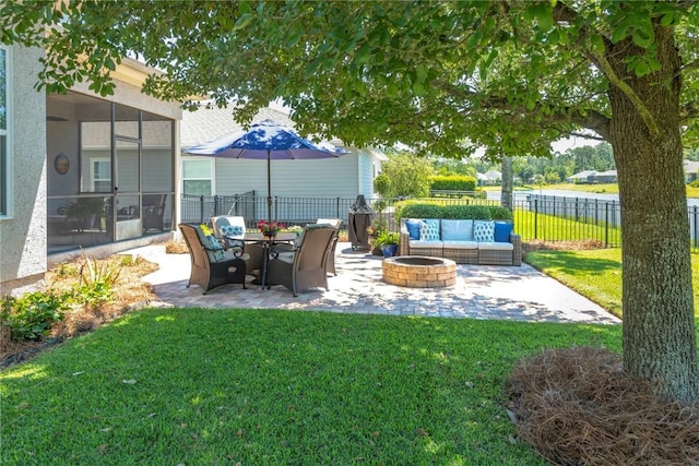 view of yard featuring a patio, an outdoor living space with a fire pit, and a sunroom