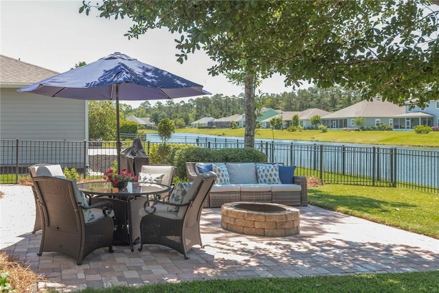 view of patio / terrace with a fire pit, a water view, and a residential view