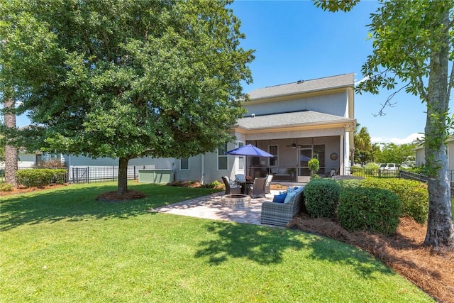 rear view of property with a ceiling fan and a patio